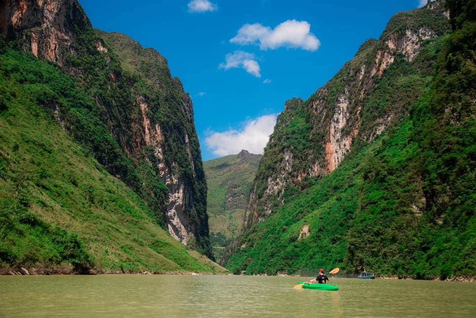 Scenic view of a kayaker navigating Tu San Canyons on the Nho Que River in Việt Nam.