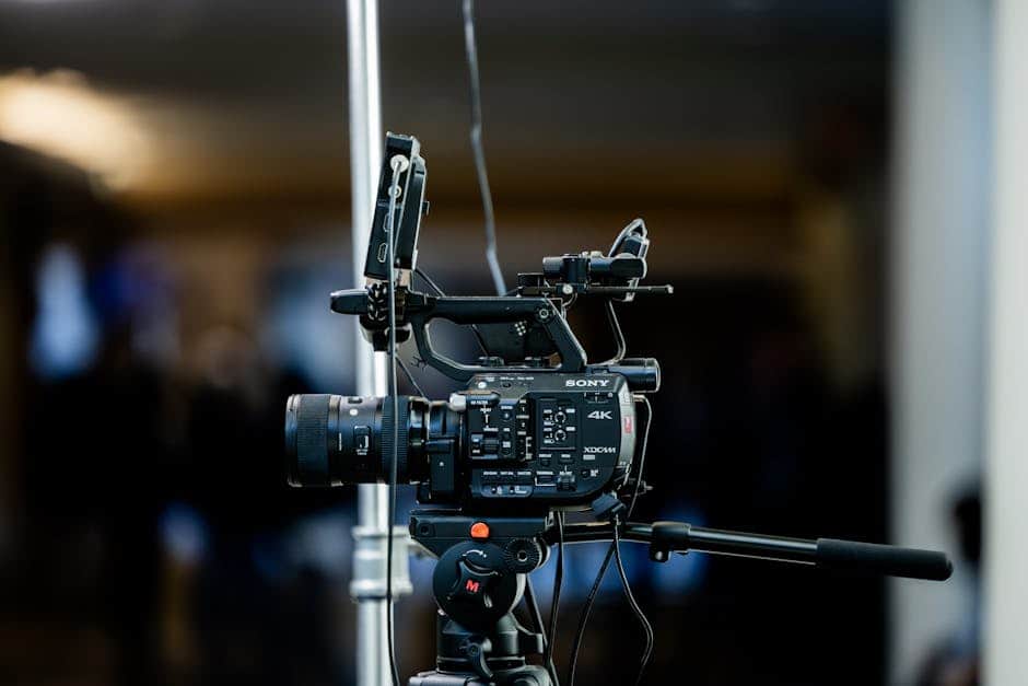 High-quality 4K video camera setup on a tripod indoors, perfect for event filming.