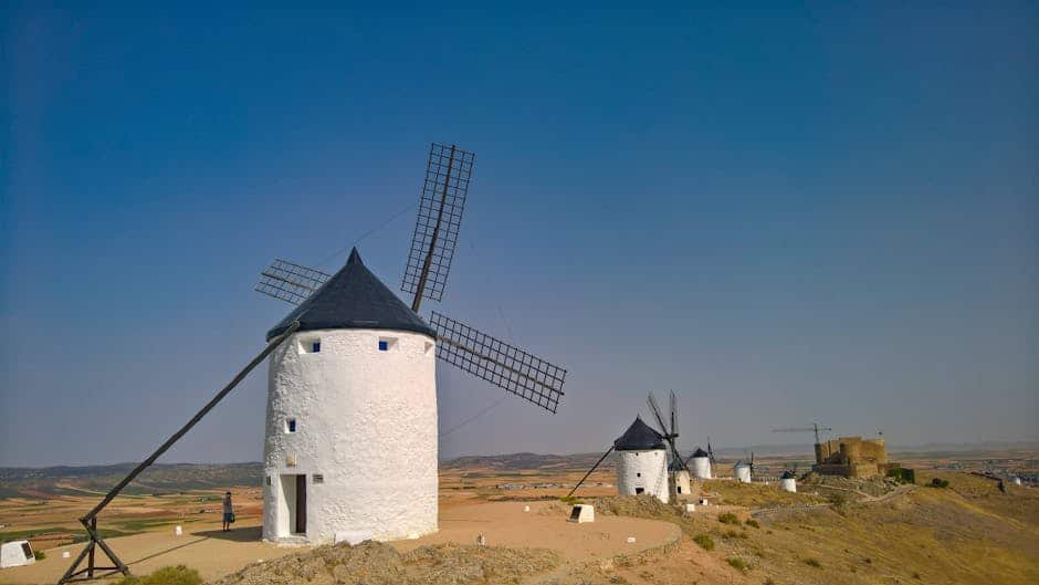 Capture of the historic windmills in Consuegra, Spain, under a clear sky.