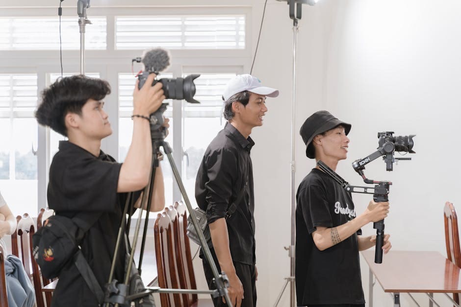Group of young videographers using professional equipment indoors in Buôn Ma Thuột.